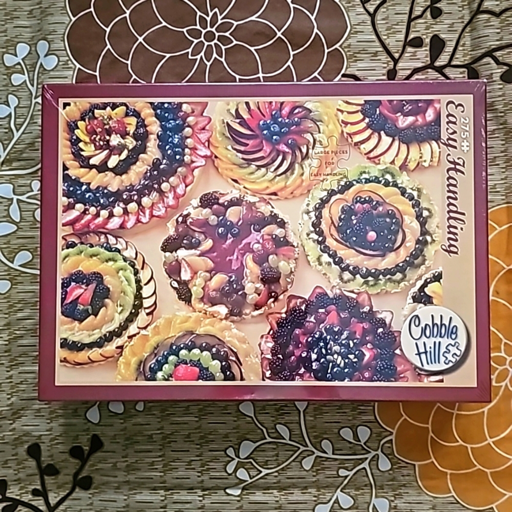 A Cobble Hill 275-Piece Fruit Tarts Puzzle Game